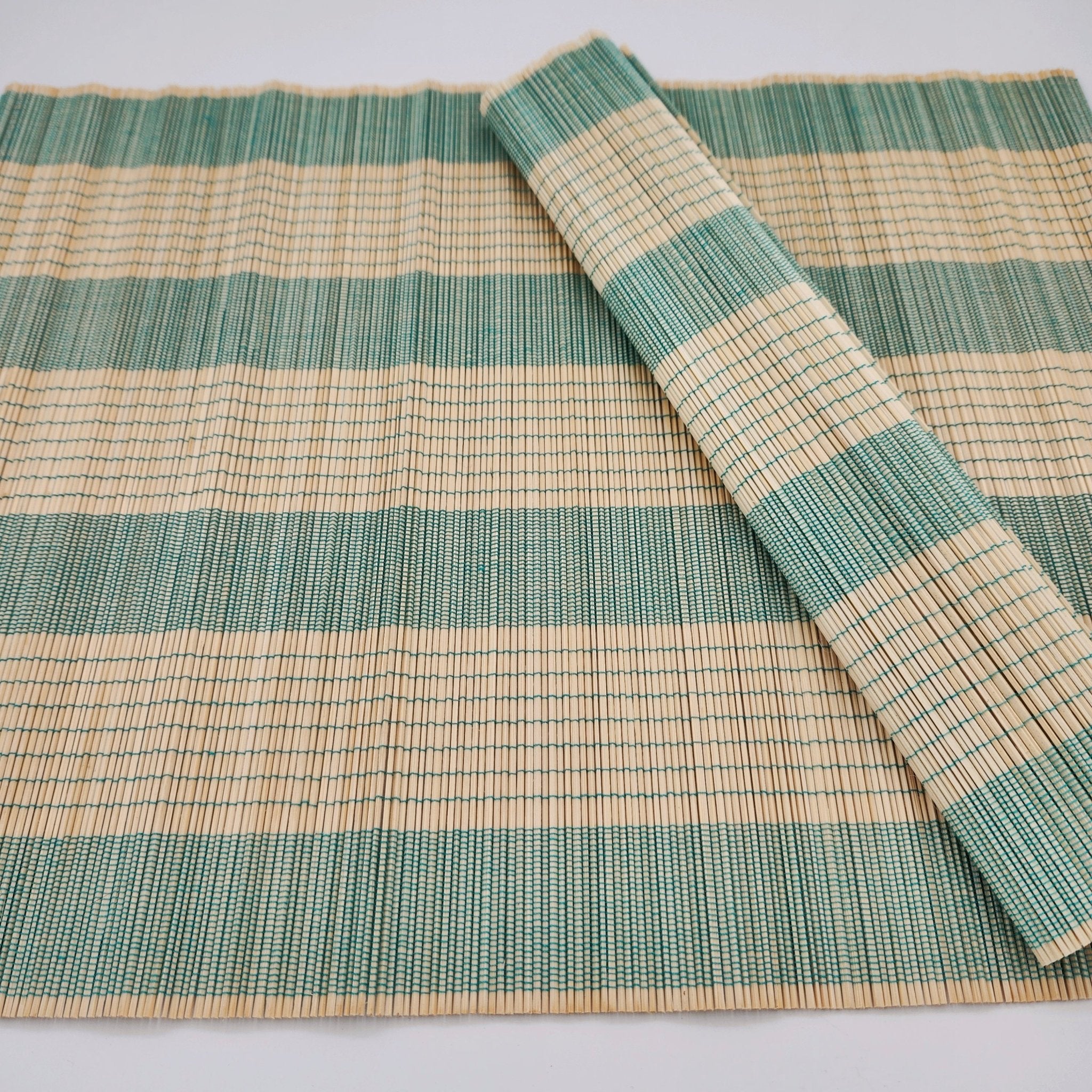Bamboo placemat in turquoise, woven bamboo table mat, a natural eco-friendly dining accent in bright turquoise.