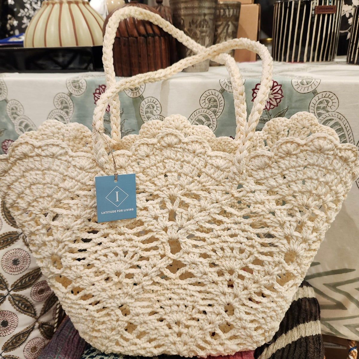Small handmade crochet bag in cream, 38 cm wide at its widest and 26 cm high not including the handles