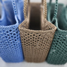 Crochet shoulder bag in water-resistant woven polyester, in dusty green or light blue, 37 x 30 x 15cm