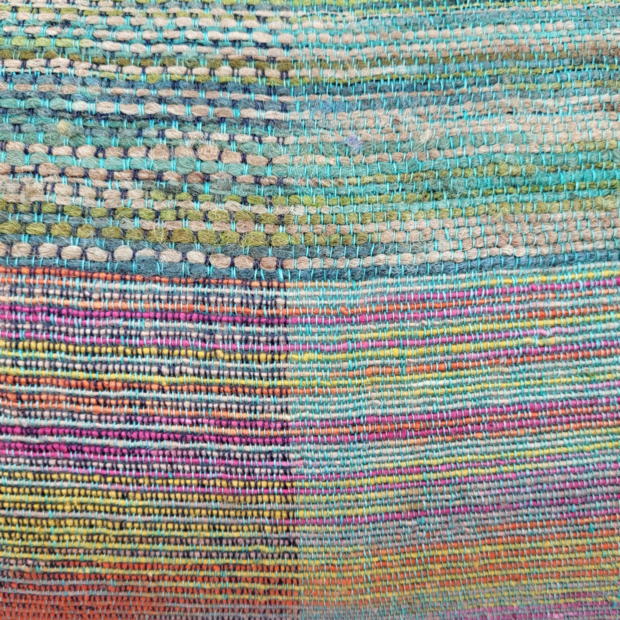 Handwoven linen and silk cushion in multicoloured rainbow shades with teal cotton back, 45 x 31 cm