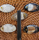 Fish-shaped chopstick rest handcrafted from horn, each with its own character, for the table