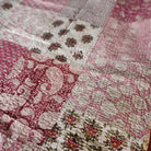 Kantha cotton throw in pink patchwork, handmade single-size quilted bedcover with running-stitch detail