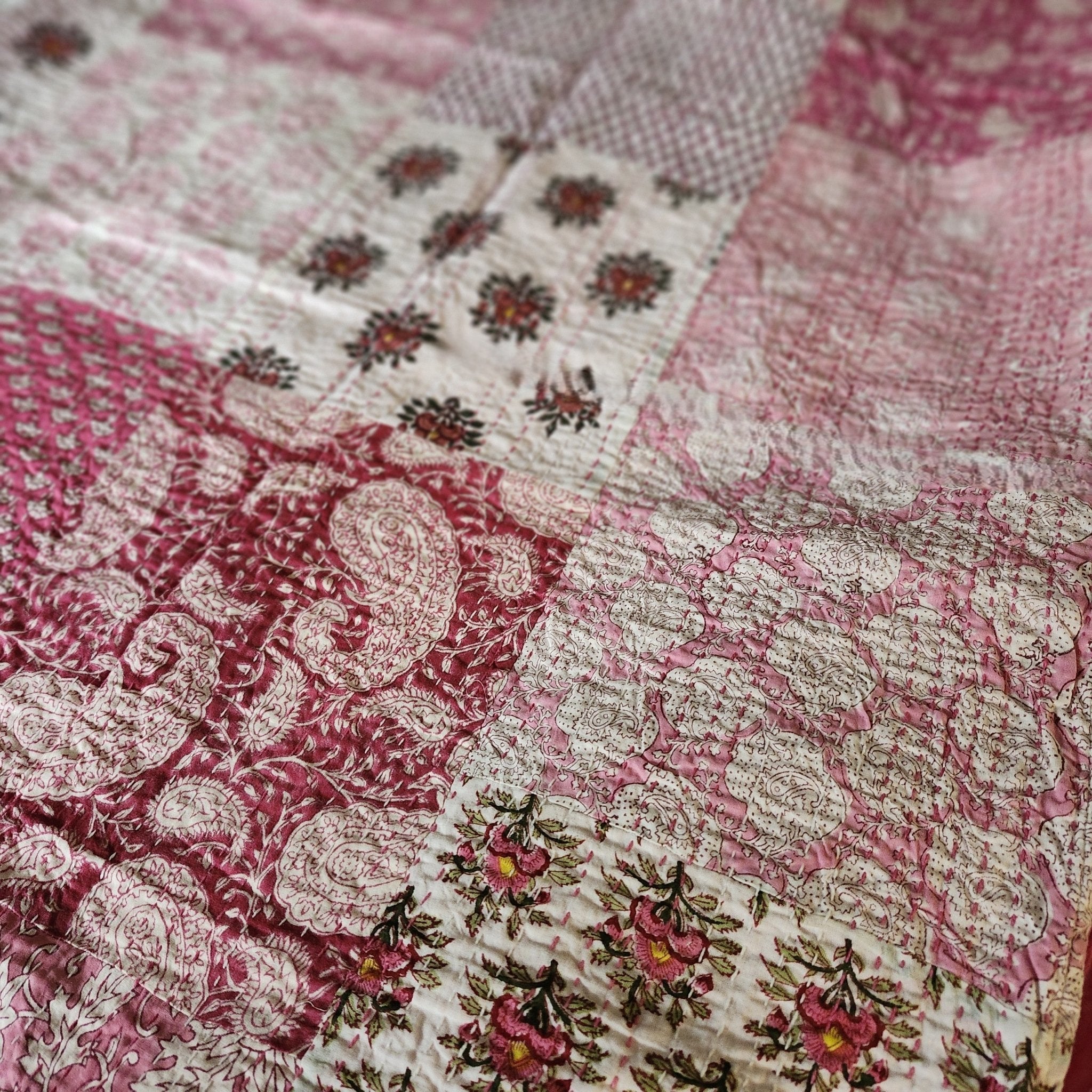 Kantha cotton throw in pink patchwork, handmade single-size quilted bedcover with running-stitch detail