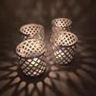 Silver painted iron tea light holder with fret-work sides, 9 cm high and 9 cm in diameter, for a single tea light