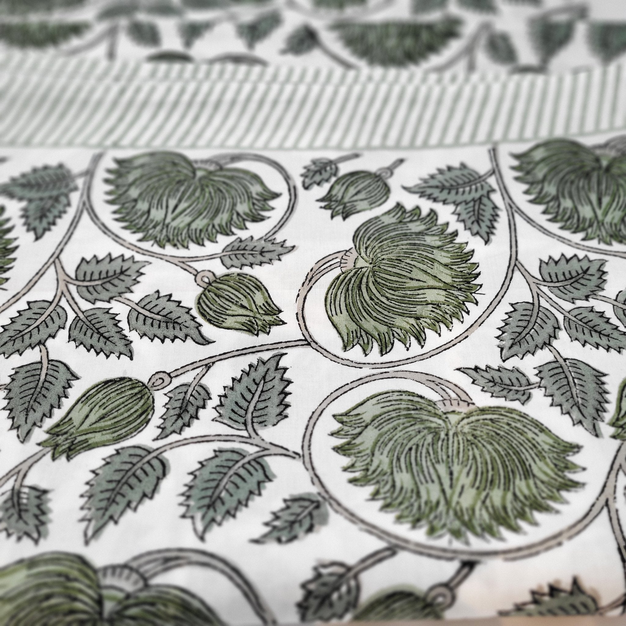 Block-print cotton tablecloth in the Lotus design, white on burgundy with striped edge, machine washable