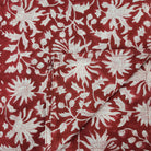 Block print cotton tablecloth in festive red, handmade hand-printed cloth for the dining table, close-up view