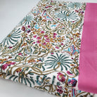 Multicoloured Rainforest block print cotton tablecloth with pink border, available in two sizes