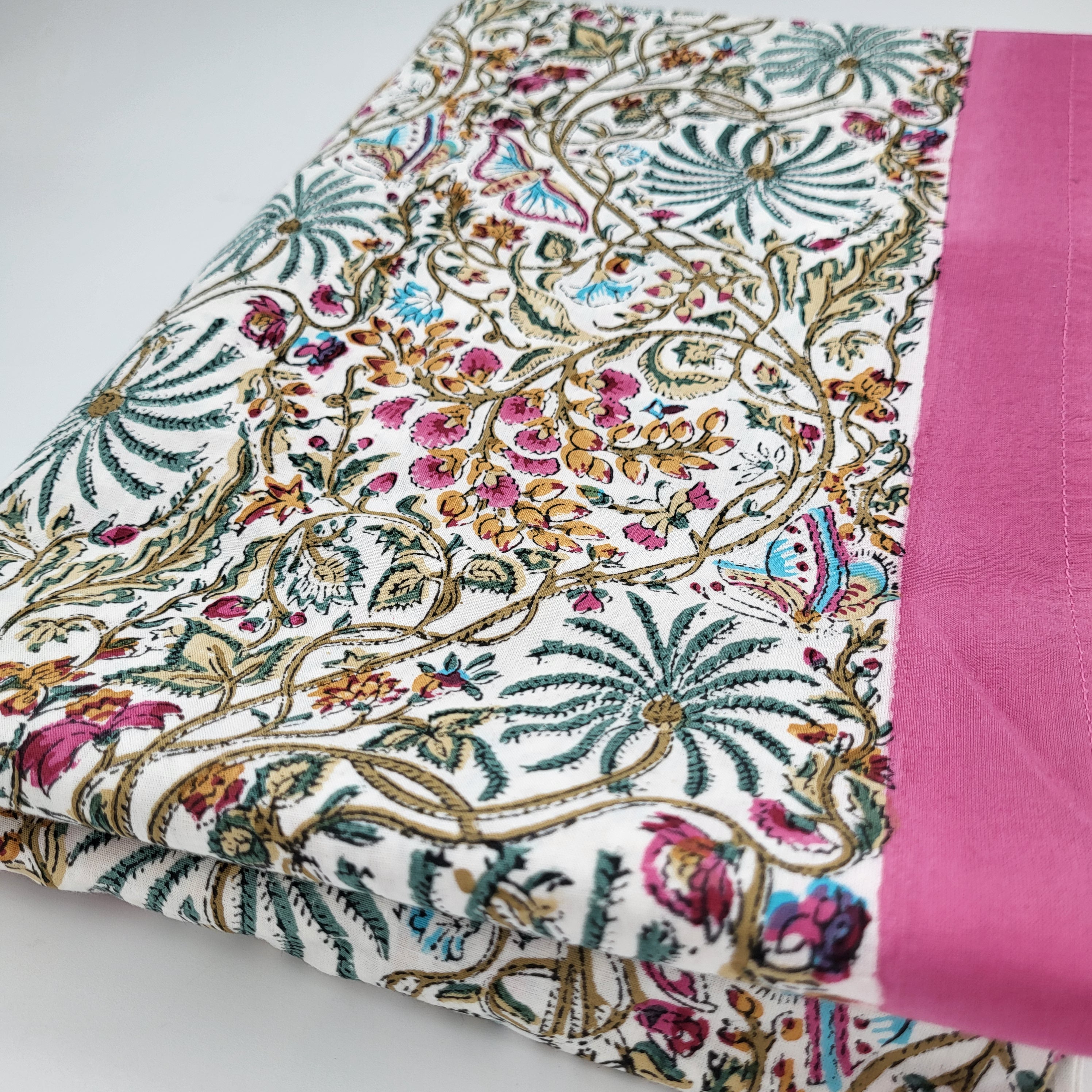 Multicoloured Rainforest block print cotton tablecloth with pink border, available in two sizes