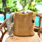 Handmade Bella raphia beach bag with a tassel, woven handles, a zip and inner pocket, three colours