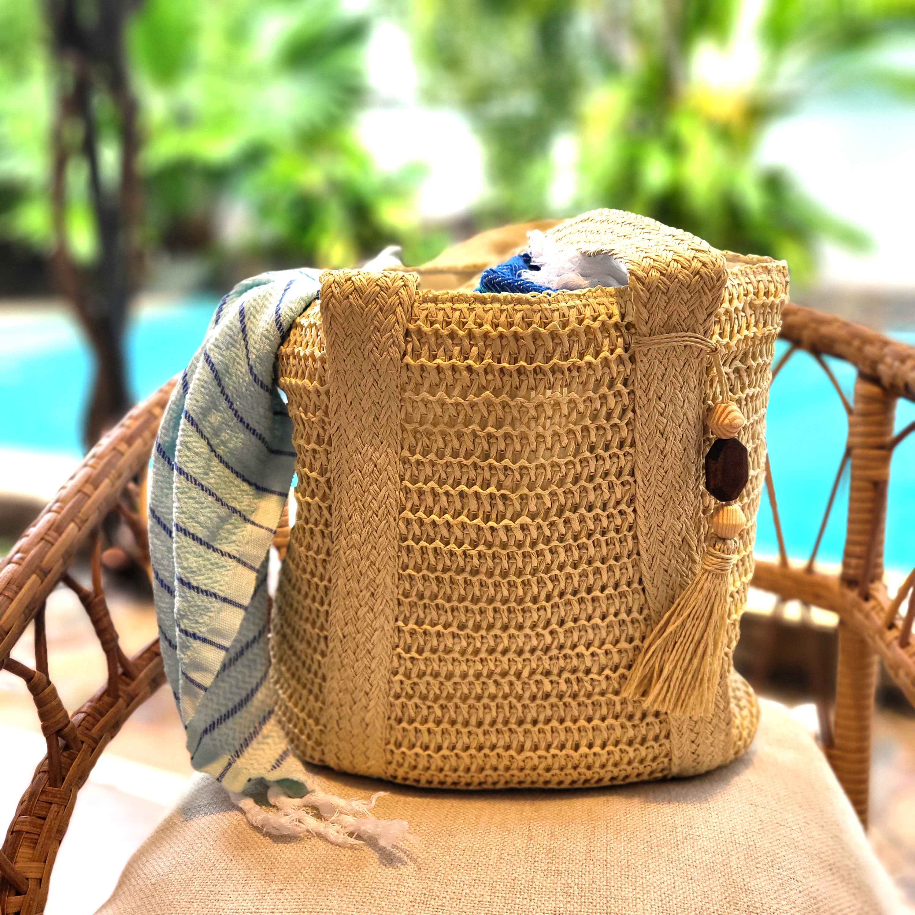 Handmade Bella raphia beach bag with a tassel, woven handles, a zip and inner pocket, three colours