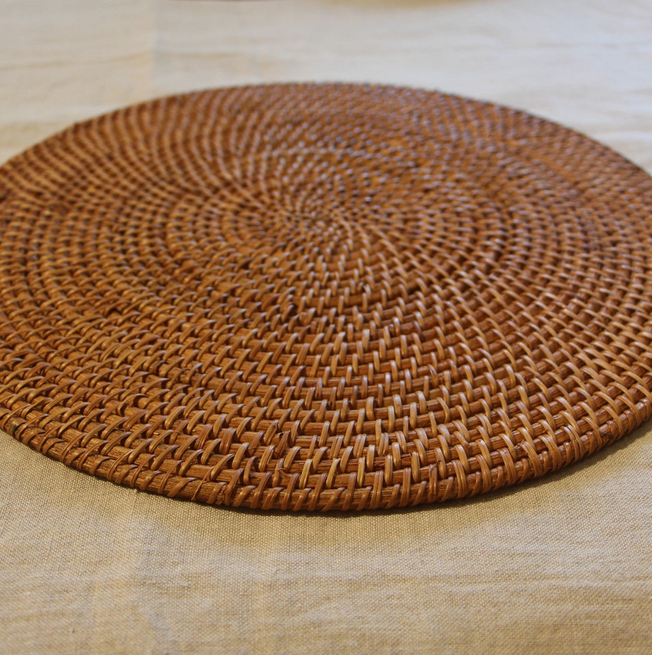 Round Rattan Placemat, side view, from the Inside Living Singapore homeware collection.