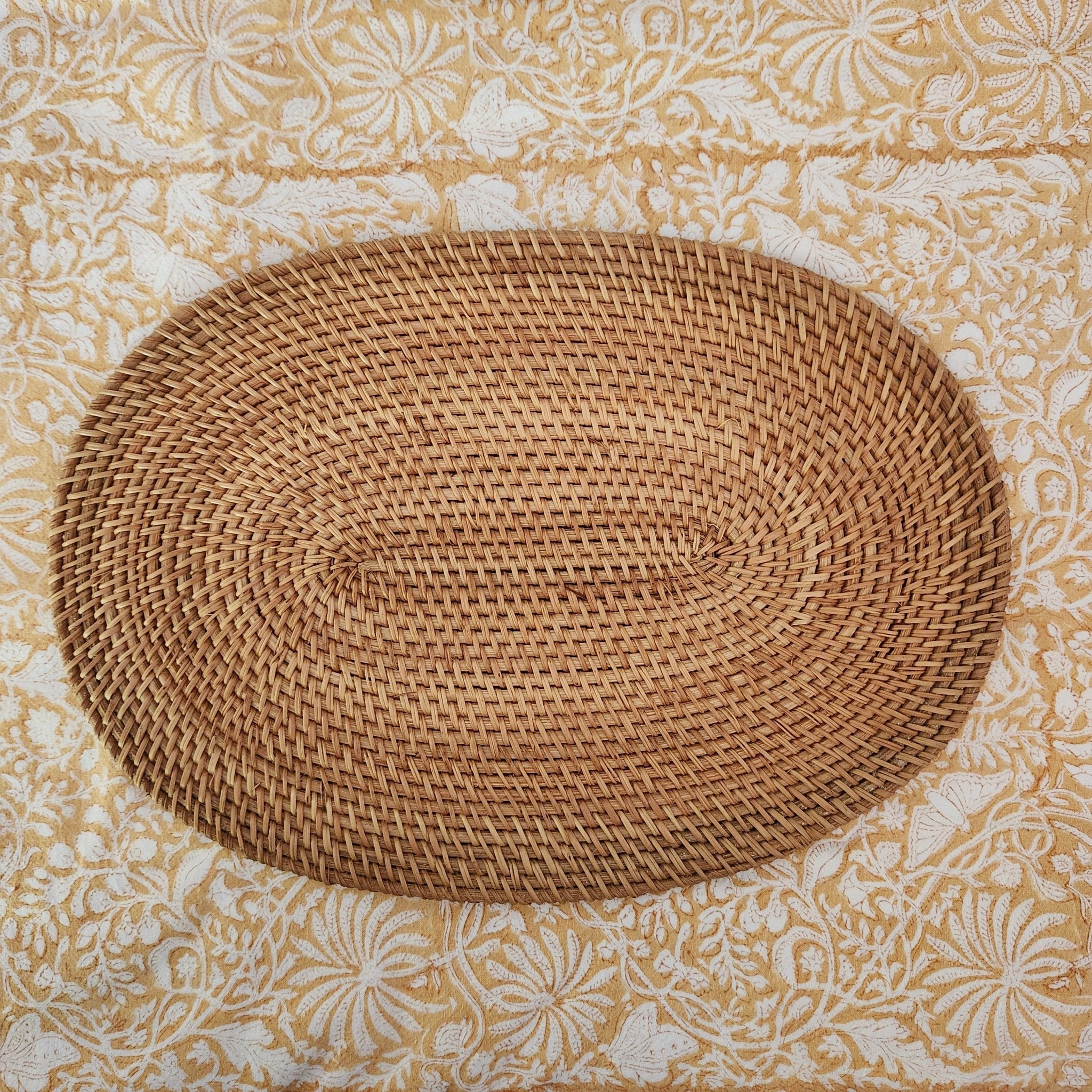 Oval handwoven natural rattan placemat, lightweight table mat for everyday and special dining, close-up view