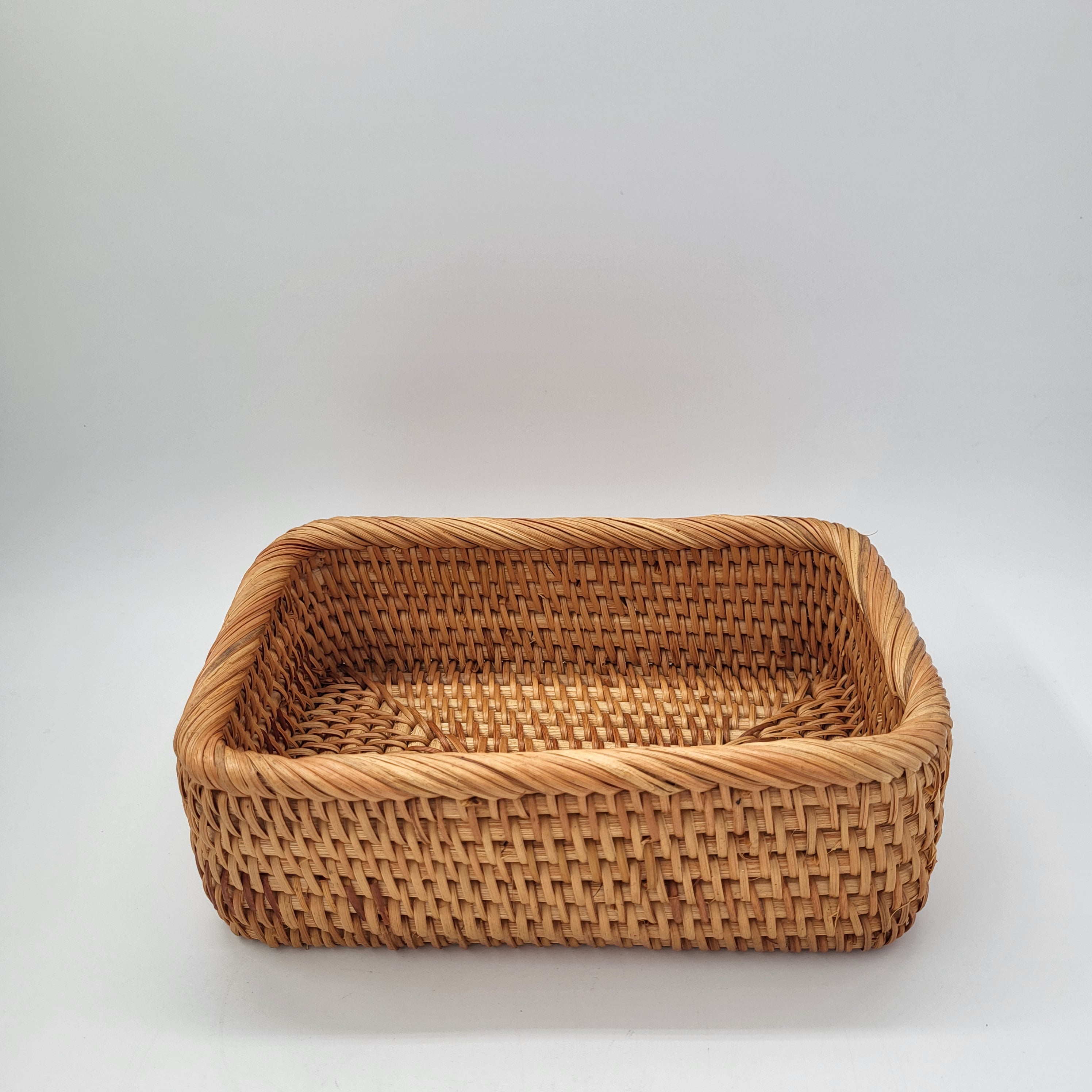 Rectangular handwoven natural rattan basket for home storage of throws, toys and household items, detail view