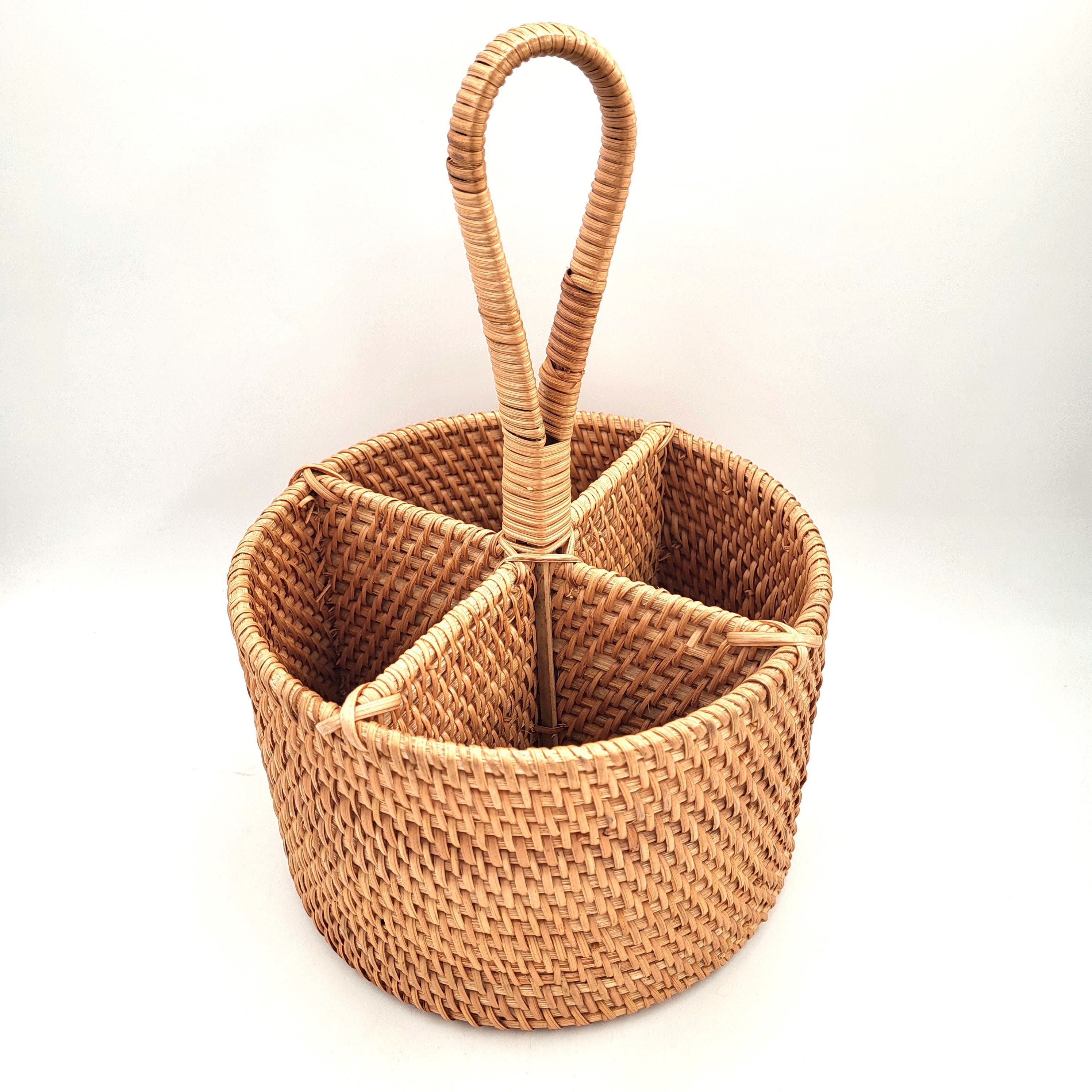 Round handwoven natural rattan utensil holder for kitchen worktop storage of cutlery and tools.