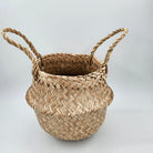 Woven seagrass basket with handles that folds into a bowl, 20cm wide by 18cm high, for storage or display