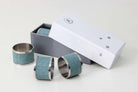 Set of 4 napkin rings in teal faux shagreen with stainless steel, 5 cm across for a dressed dining table