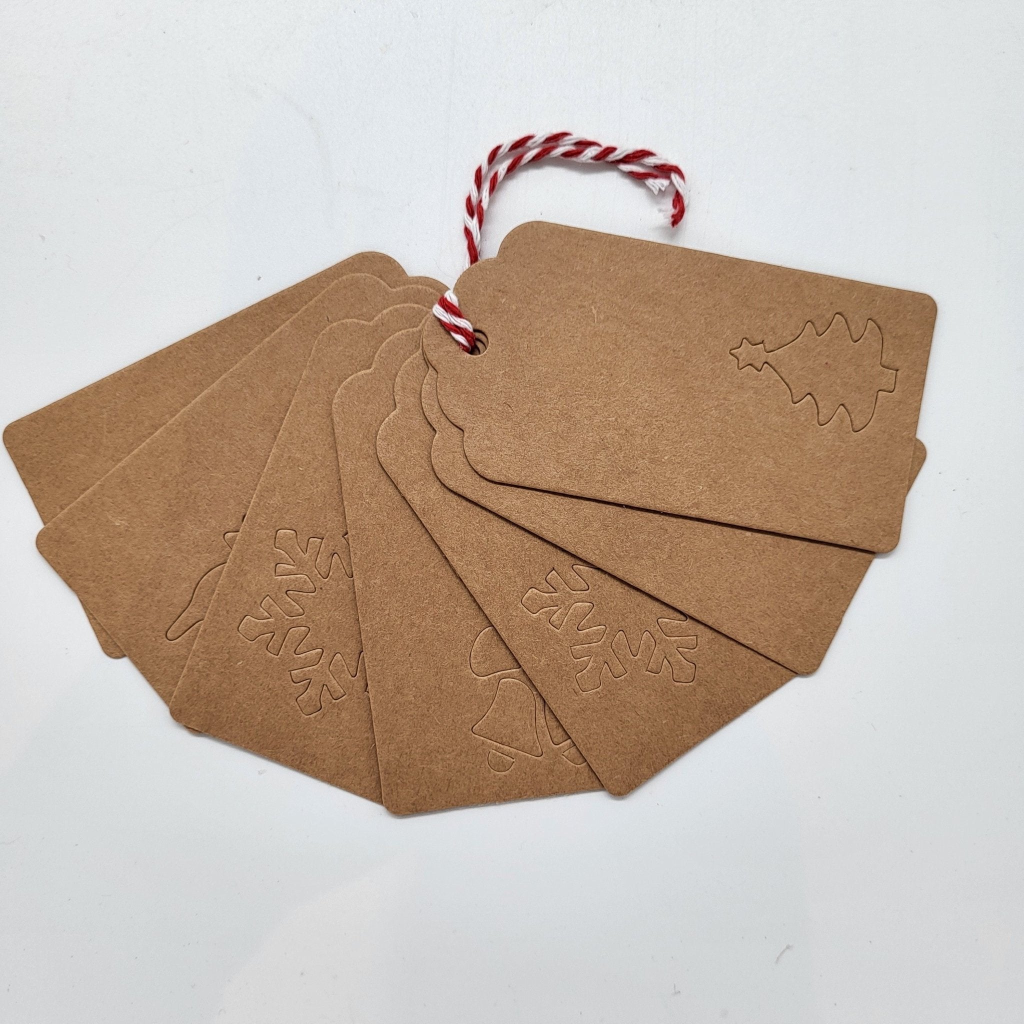 Pack of eight Christmas card gift tags with punched motifs and string ties, 5 x 10 cm