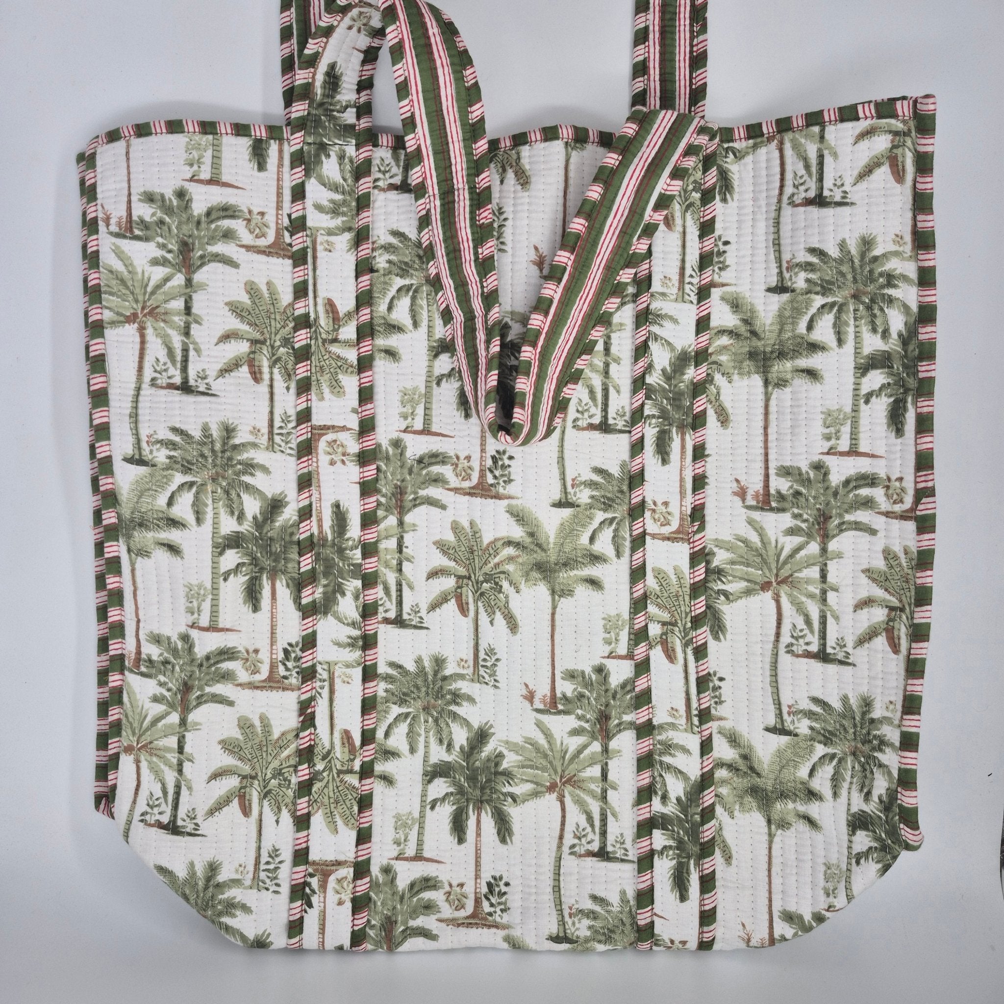 Quilted cotton shopper bag in white with a blue palm print, contrast lining, inner pocket and zip