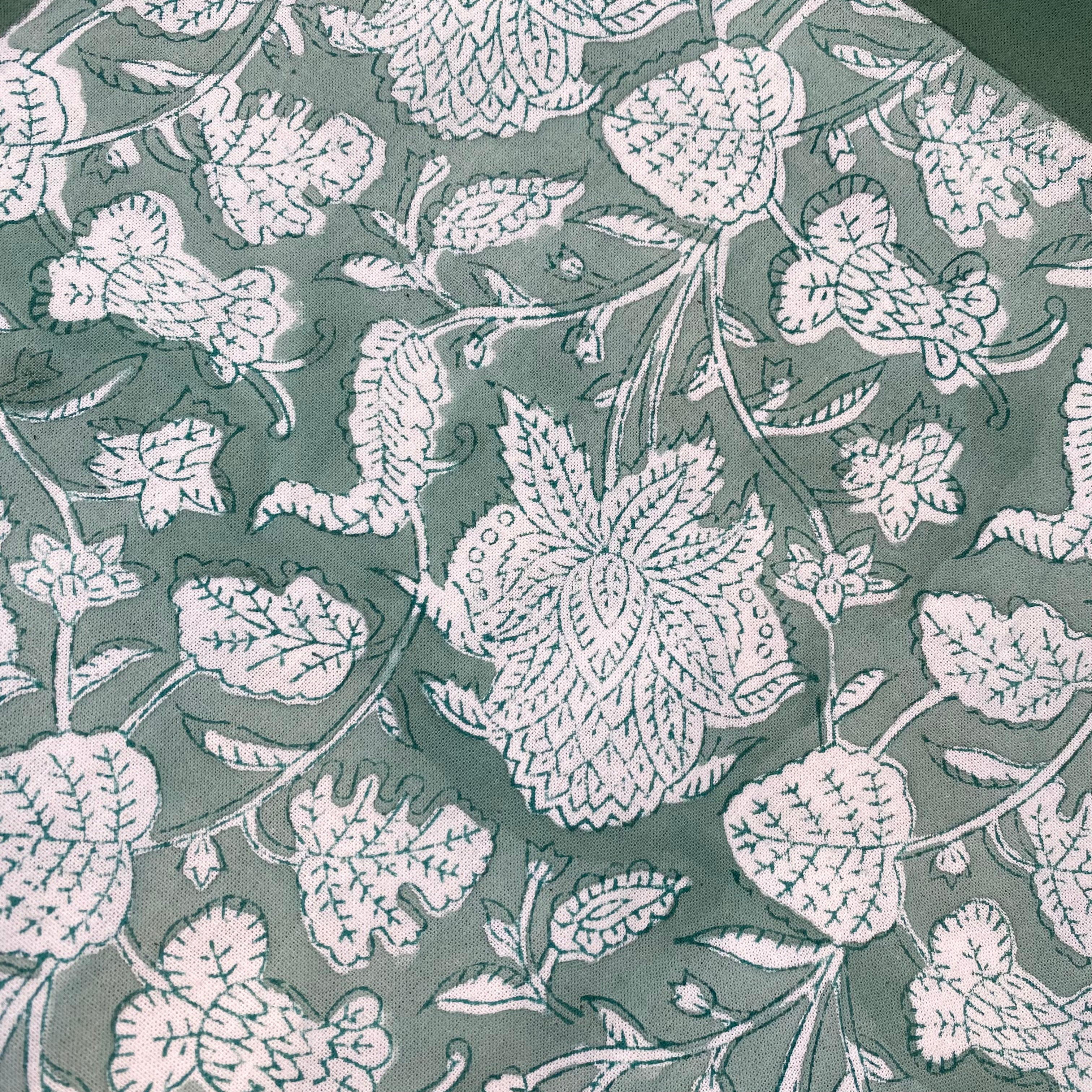 Cotton block-printed tablecloth with a classic teal floral print on white, available in seven sizes