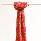 Handwoven silk scarf in a red polka dot design, lightweight artisan scarf, an elegant accessory for any season.