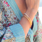 Bangle handcrafted from horn with a gold lacquer finish, lovely worn alone or stacked, in two sizes
