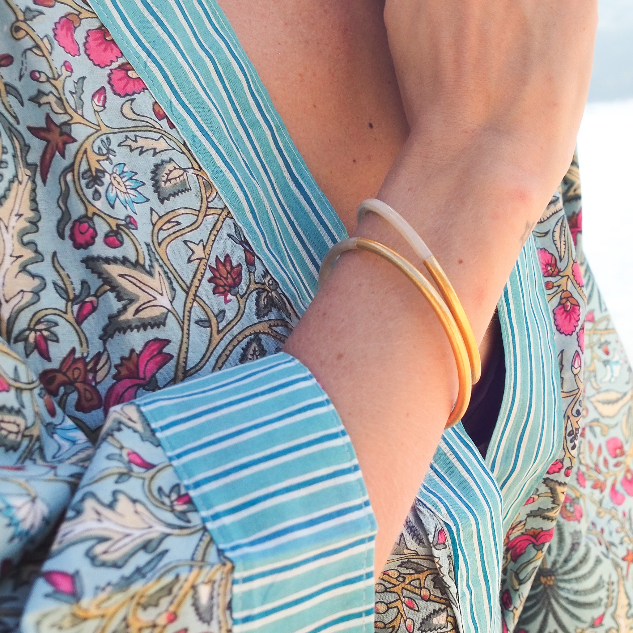 Bangle handcrafted from horn with a gold lacquer finish, lovely worn alone or stacked, in two sizes