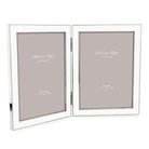 Double white enamel and silver-plate photo frame holding two 5 x 7 inch portrait photos