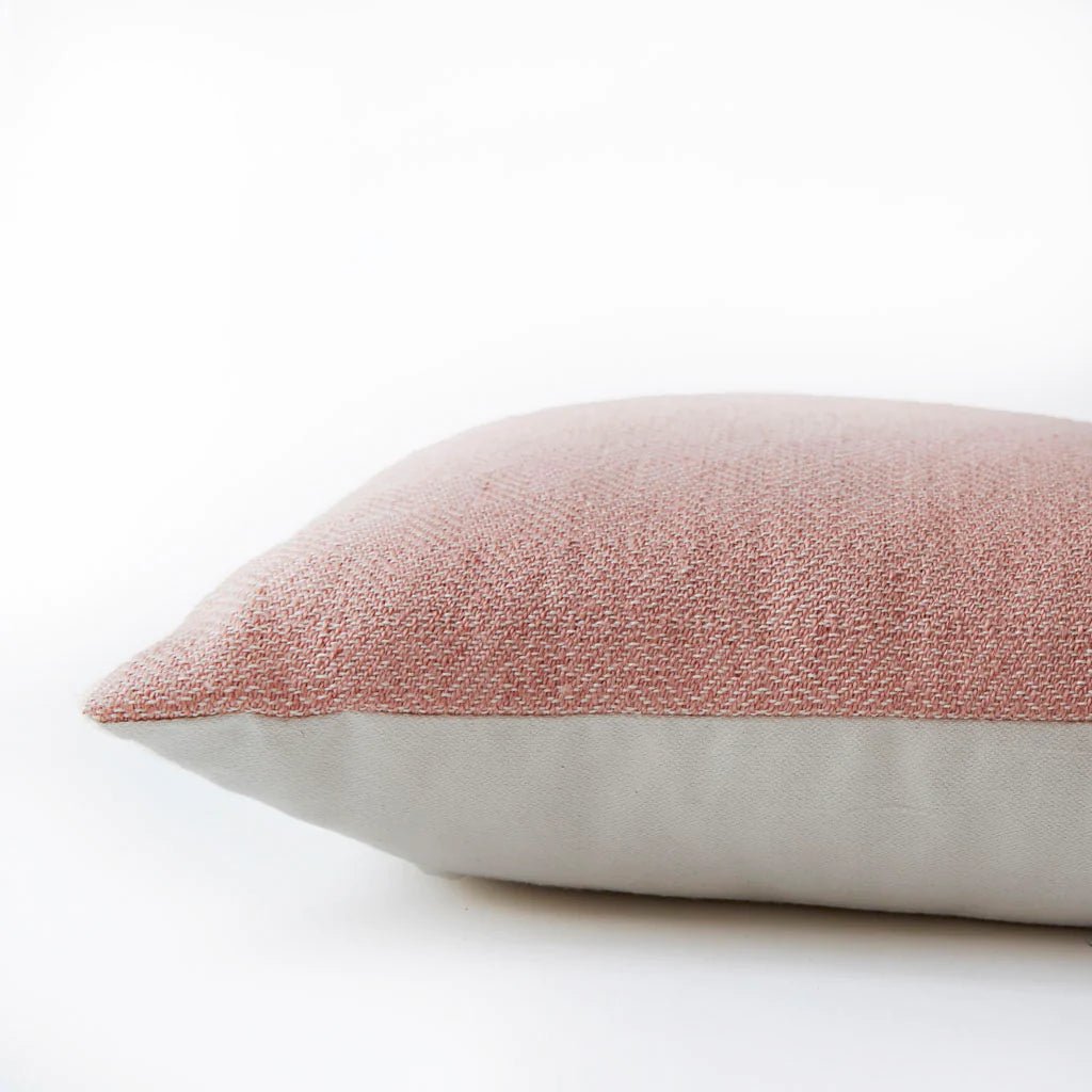 Coral diamond cushion detail, geometric patterned cushion in coral adding colour to a sofa, bed or chair.