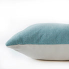 Teal diamond cushion detail, geometric patterned cushion in rich teal adding colour to a sofa or chair.