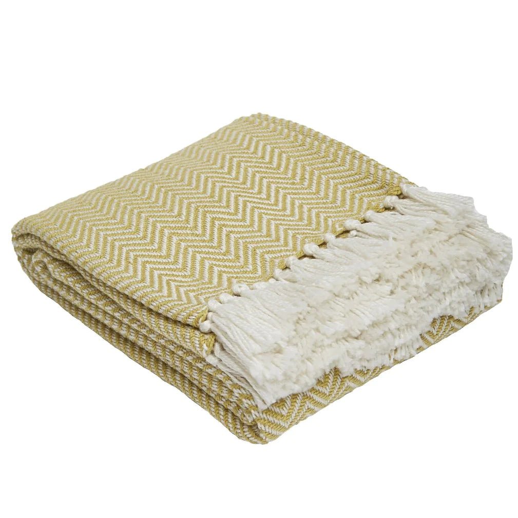 Gooseberry herringbone blanket, soft woven throw in a green herringbone weave for cosy sofa or bed layering.