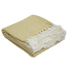 Gooseberry herringbone blanket, soft woven throw in a green herringbone weave for cosy sofa or bed layering.