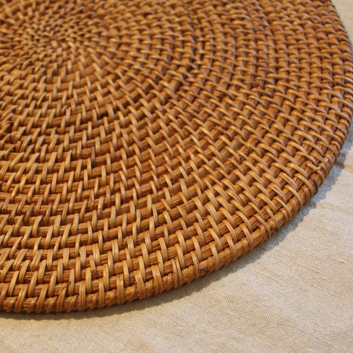 Round Rattan Placemat, detail view, from the Inside Living Singapore homeware collection.
