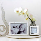Mother of pearl and silver-plate alarm clock with black velvet back, 9 x 9 x 5 cm