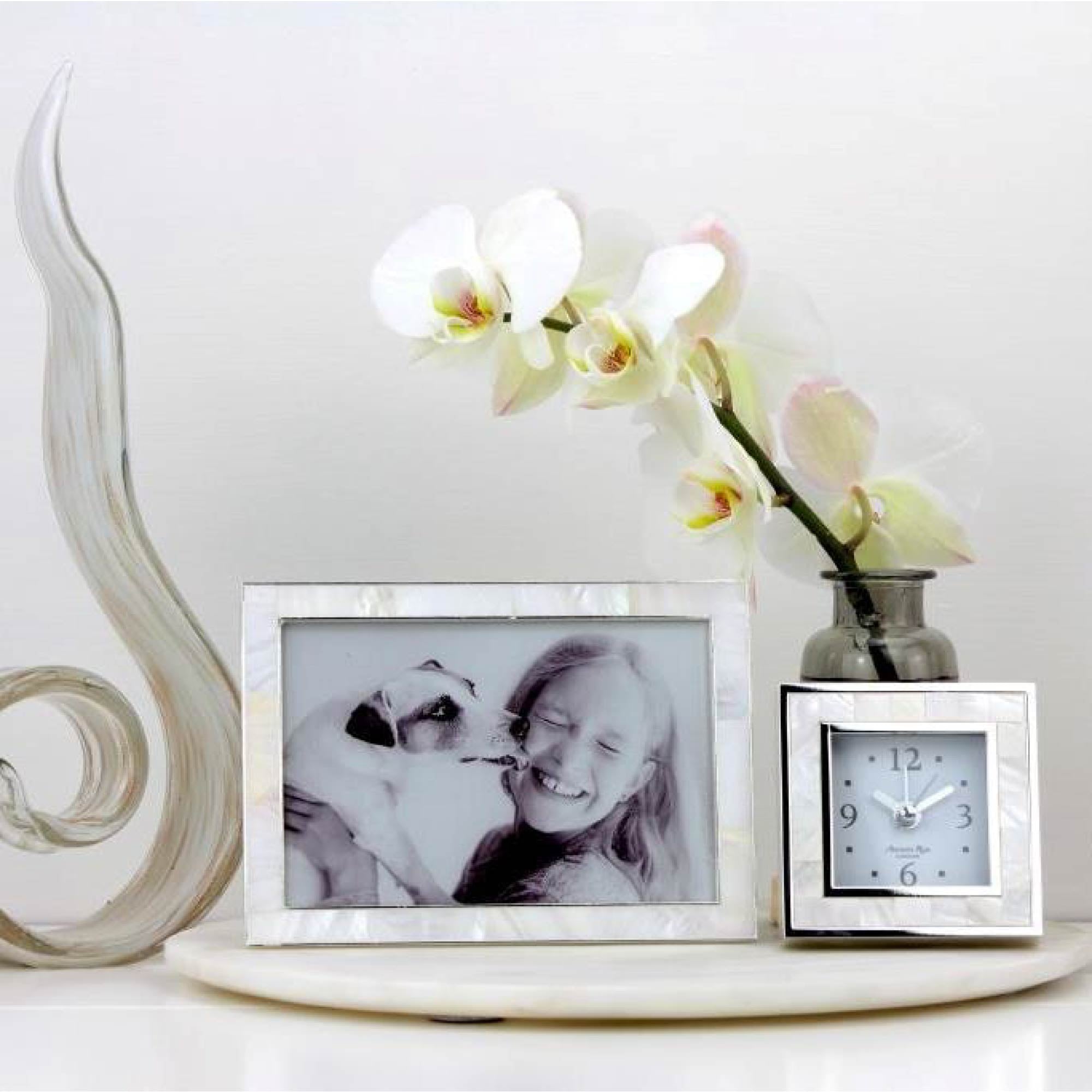 Mother of pearl and silver-plate alarm clock with black velvet back, 9 x 9 x 5 cm