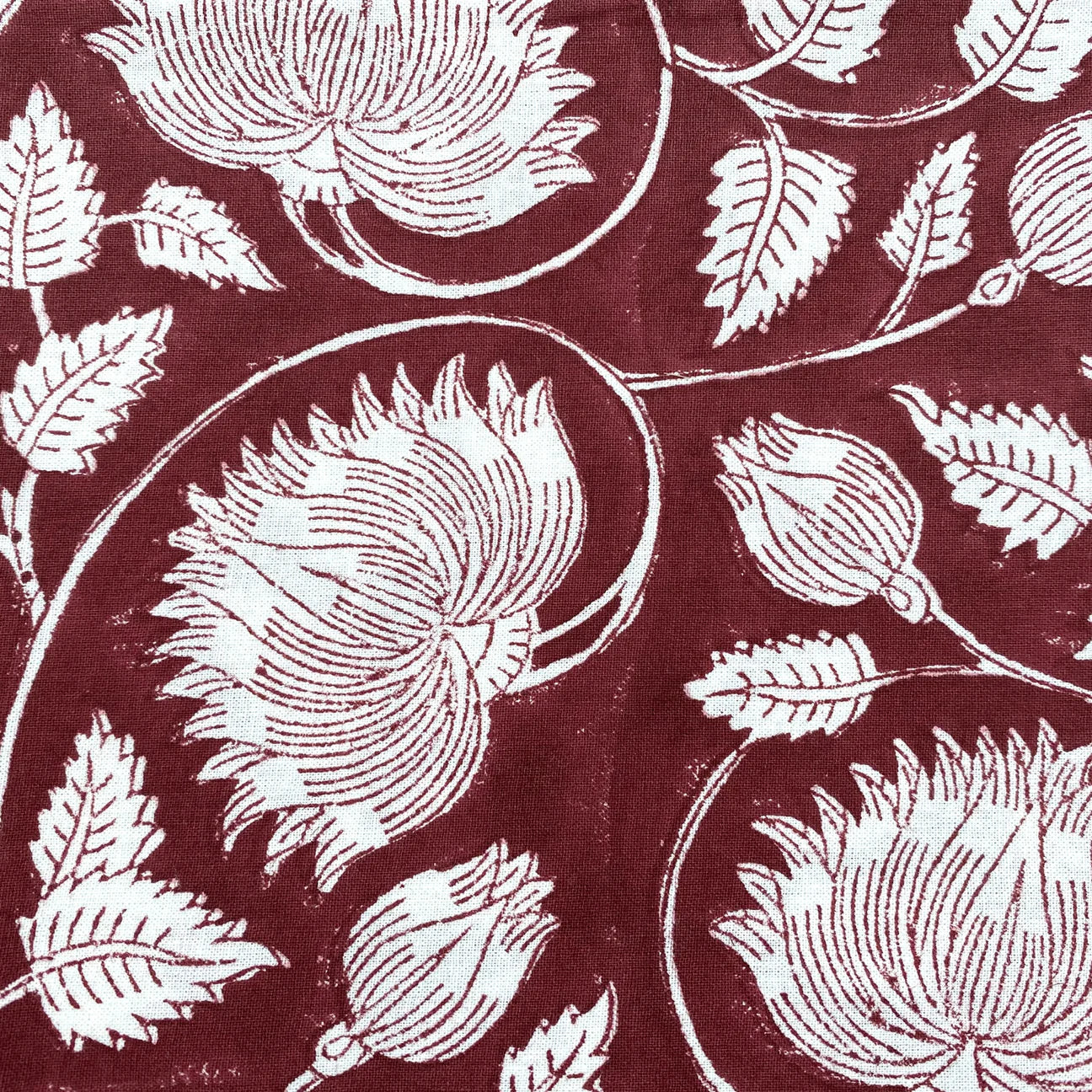 Block-print cotton tablecloth in burgundy lotus design, 170 x 270 cm, from Inside Living Singapore Front view.