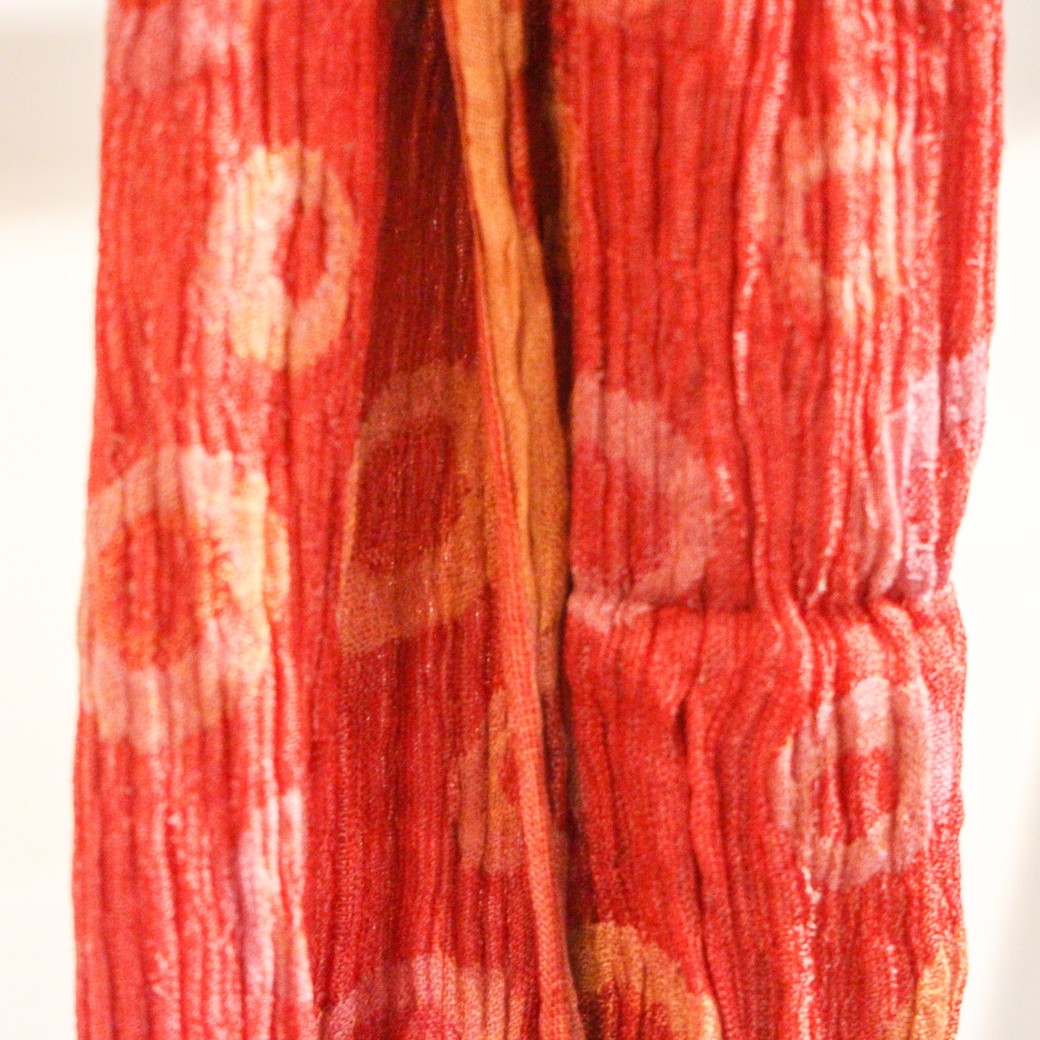 Handwoven silk scarf styled, red polka dot design, an artisan silk accessory adding colour to any outfit.