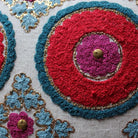 Suzani Kokand red linen cushion, 45 x 45 cm, with embroidered floral motif, from Inside Living Singapore Side view.