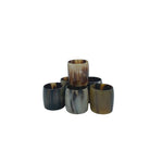 Set of six napkin rings hand-carved from naturally shed horn, each with unique earthy hues, for rustic table settings