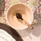 Horn teaspoon with a bamboo handle, handcrafted natural serving spoon, an eco-friendly accent for table or kitchen.